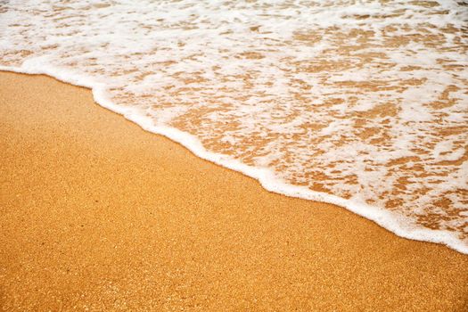 Top view over beach sea. Beautiful sea waves. Beach sand and amazing sea. Summer seascape. Water texture background.