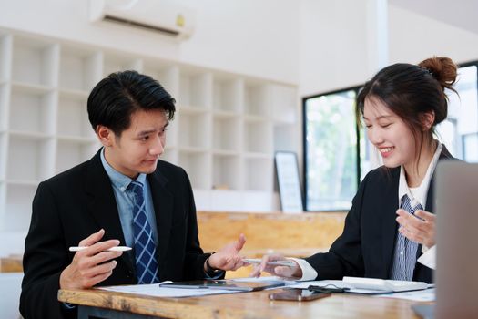 Asian portrait of people working together on a new project to analyze budgets and manage investment risks in today's profit boosting for marketing in the office room.