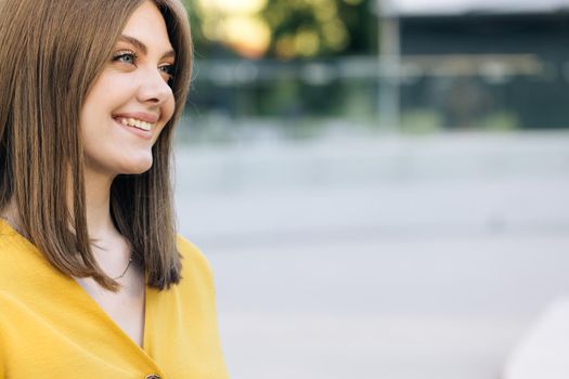 Face attractive brunette woman at sunset smiling beautiful around blue eyes. Stand outdoor relax. Happy relax.