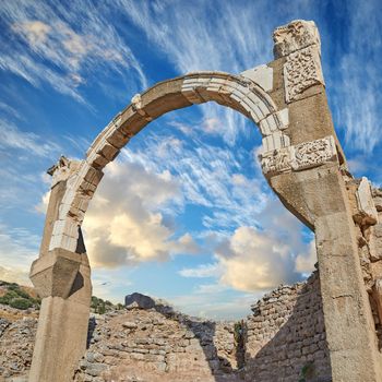 Old dilapidated city of Ephesus, Turkey under cloudy sky. Sightseeing and overseas travel for holiday, vacation and tourism. Excavated remains of historical structure from ancient history and culture.