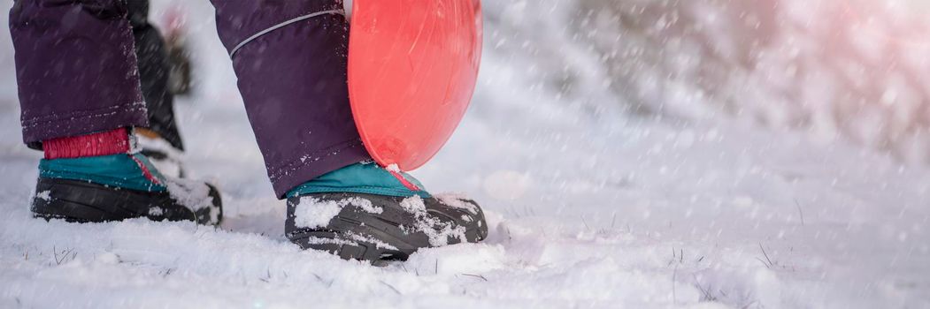 Winter shoes in the snow. Close-up of winter shoes. Children's waterproof shoes for walking in the snow. Low temperature and falling snow.