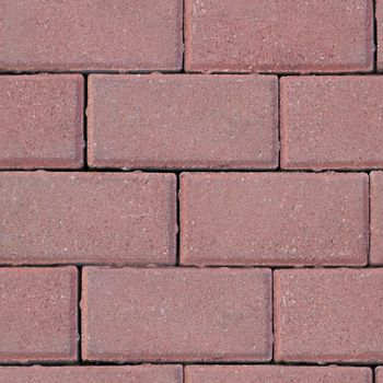 Seamless texture of masonry road made of dark pink brick. Top view