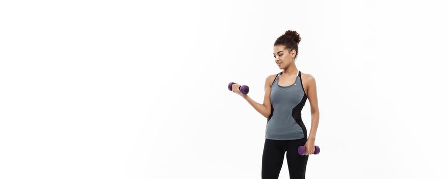 Healthy and Fitness concept - Full-length of portrait Beautiful American African lady in grey fitness clothes workout with dumbbell. Isolated on white background