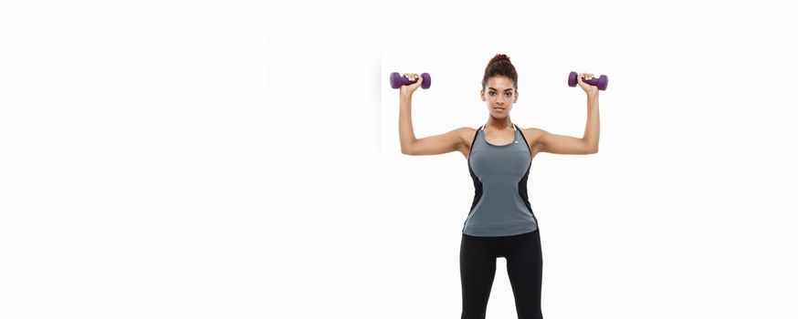 Healthy and Fitness concept - Full-length of portrait Beautiful American African lady in grey fitness clothes workout with dumbbell. Isolated on white background