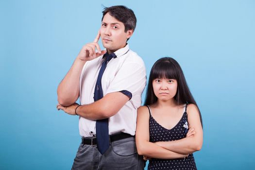 Portrait of serious interracial couple looking at the camera. Asian girlfriend.