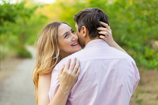 Adult couple in love outdoor. Stunning sensual outdoor portrait of young hugging couple posing in summer in field