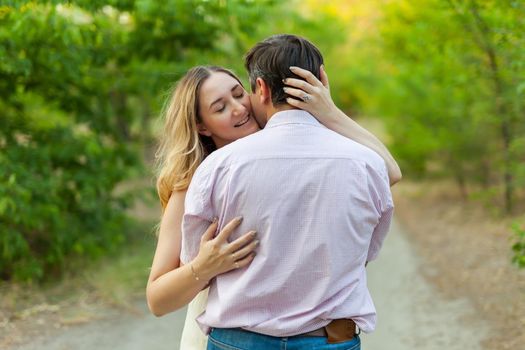 Adult couple in love outdoor. Stunning sensual outdoor portrait of young hugging couple posing in summer in field