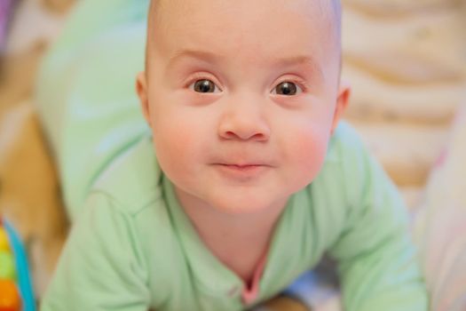 Beautiful smiling cute baby. Beautiful expressive adorable happy cute laughing smiling baby infant face. Children, people, infancy and age concept - beautiful happy baby