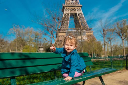 Children in Paris near the Eiffel Tower. Selective focus. Kid.