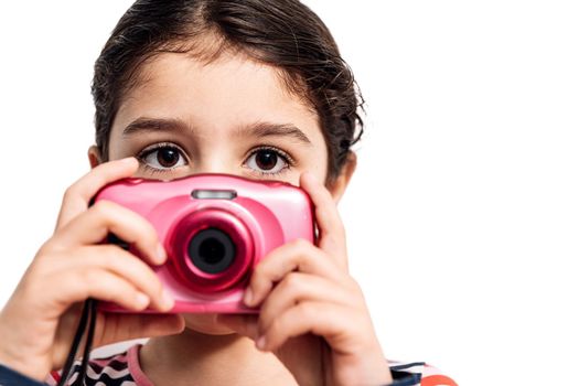horizontal photo of a child looking at camera isolated on a white background taking photos, concept of kids and their hobbies, copy space for text