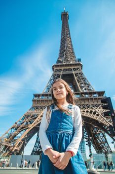 Child in Paris near the Eiffel Tower. Selective focus. Kid.