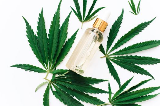 Hemp CBD oil in a bottle on a white background with hemp leaves, biomedicine and ecology, hemp grass, medicine, cbd oil from a medical extract