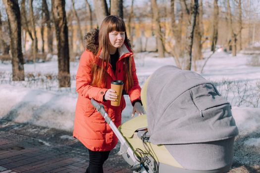 Mom on a walk with a stroller lifestyle. An article about choosing a stroller. An article about walking with children. The use of fresh air for kids. Modern moms. City walks with a stroller .