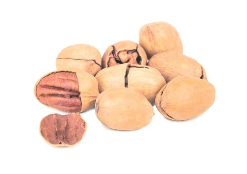 Bunch of inshell pecans on white background