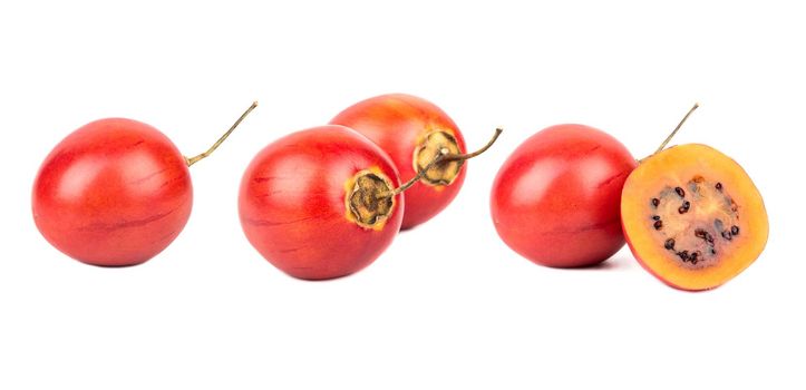 Fresh, juicy tamarillo fruit with half isolate on a white background, set