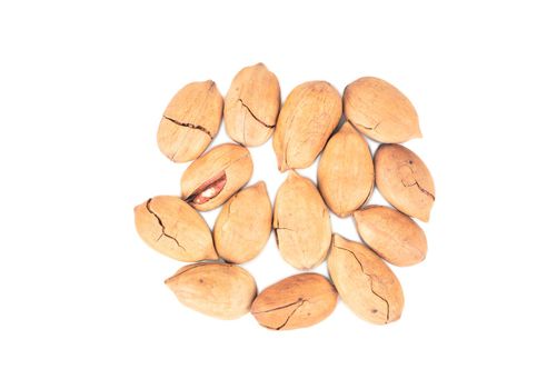 Bunch of organic pecans in shell on white background, top view