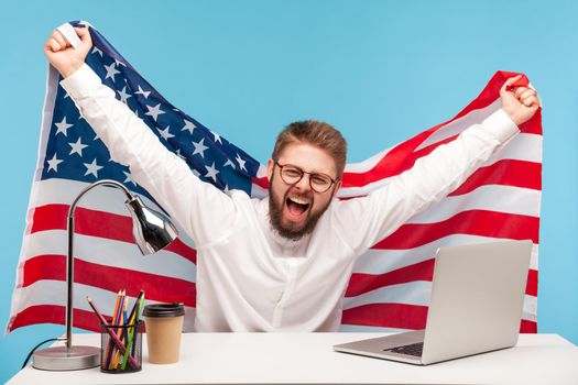 Extremely happy businessman raising American flag, yelling crazy joy in office workplace, celebrating labor day or US Independence day 4th of july, government employment support. indoor, isolated