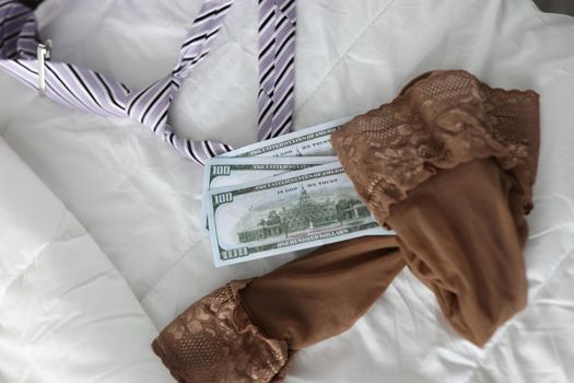 Women stockings men tie and cash dollar bills. Intimate services and sex for money concept
