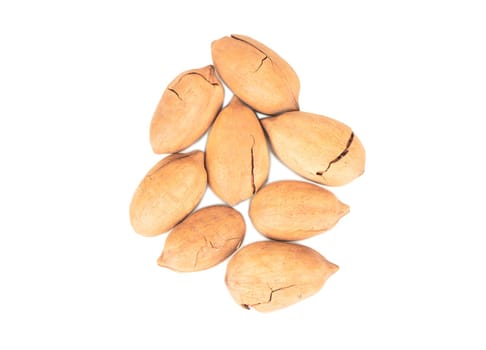 Heap of pecan nuts in broken shell on white background top view