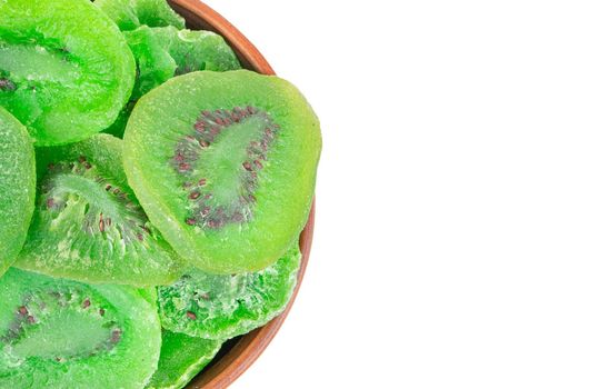 Part of a bowl with dry slices of kiwi fruit close-up, top view