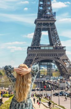 Woman near the eiffel tower. Selective focus. People.