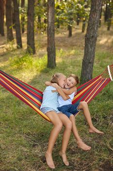 Fun in the garden. lovely kids playing in colorful hammock