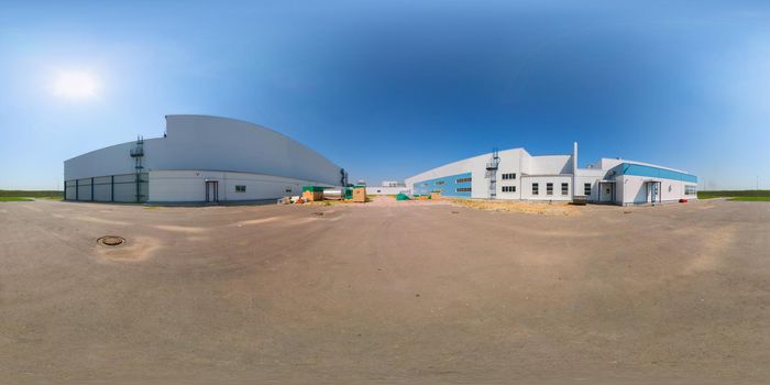 Seamless full spherical 360 degree panorama in equirectangular projection of outdoor industrial area with white buildings aphalt parking at sunny summer day