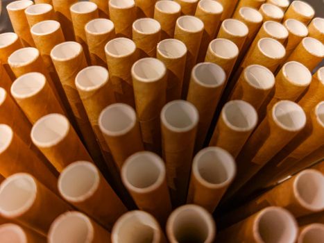 Stack of paper straws standing in high glass 