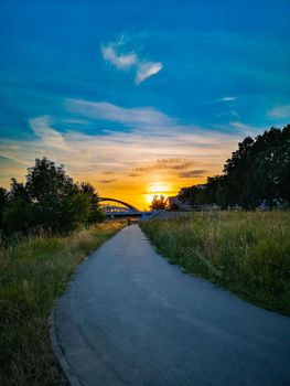 Long path next to city shafts to beautiful cloudy sunset