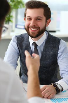 Smiling businessman communicates with business project partner. Business consultant discussing financial report
