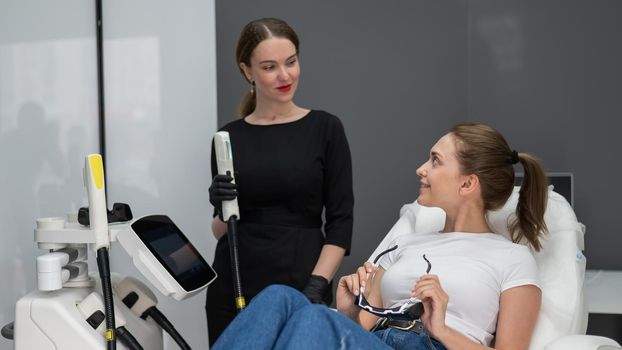 Young caucasian woman on photorejuvenation procedure. Portrait of a girl in a beautician's clinic