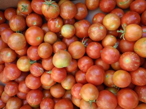 Bunch of Red-Orange Cherry Tomatos at a farmers market in San Francisco, California
