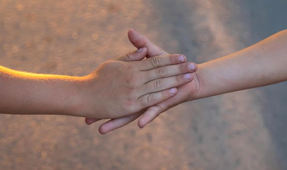 Children walk hand in hand. Selective focus. Kids,