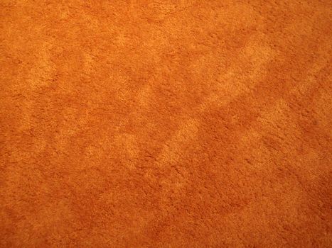 Close-up of an orange indoor shag carpet.  With a 70's look