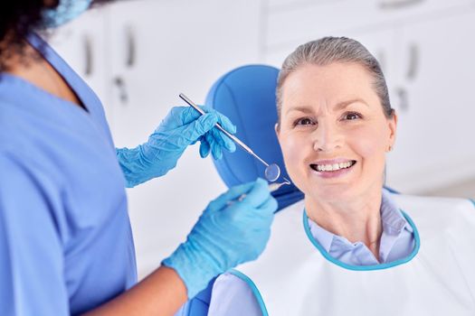 Shot of a woman and her dentist in the office.