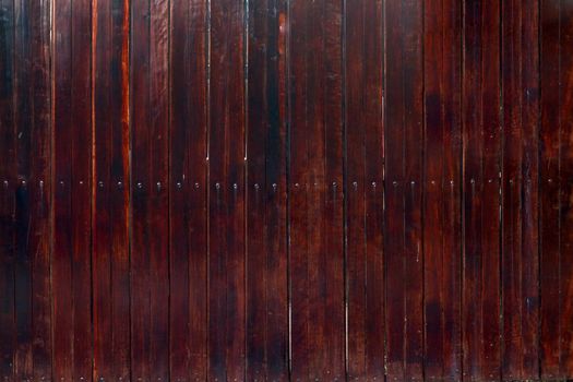 The texture of dark wood planks vertical