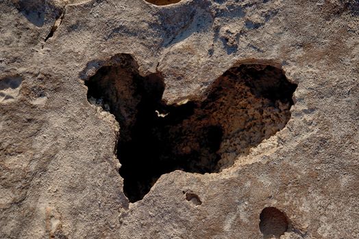 Hole in a rock in the shape of a heart.