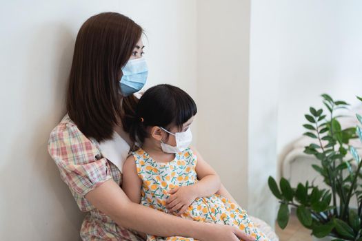 Asian girl and mother wearing masks are waiting for covid-19 tests, the situation of coviral-19 prevention of covid health care Prevent infection with the covid 19 virus.