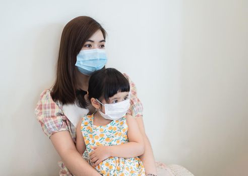 Asian girl and mother wearing masks are waiting for covid-19 tests, the situation of coviral-19 prevention of covid health care Prevent infection with the covid 19 virus.