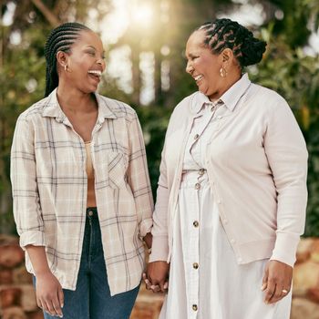 Shot of a senior woman spending time with her daughter in their garden at home.