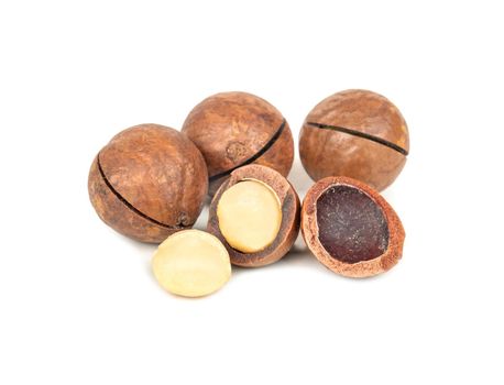 Delicious macadamia nuts with kernels on a white background