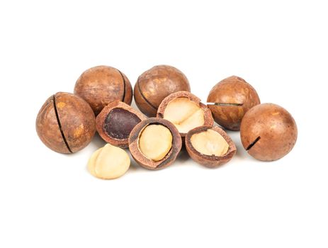 Macadamia nuts in a shell and without on a white background