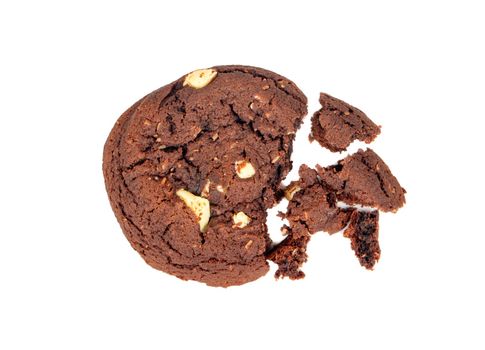 Broken homemade chocolate cookies on a white background, top view