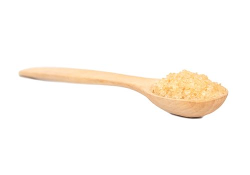 Wooden spoon with brown sugar on a white background