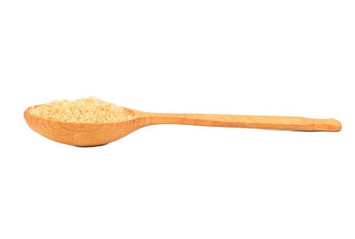 Brown sugar in a wooden spoon isolated on a white background