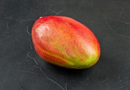 Red ripe mango fruit on a dark background