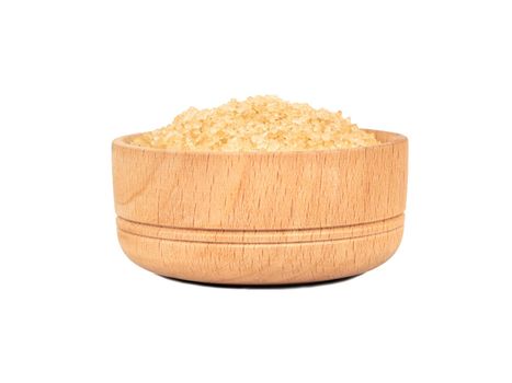 Wooden bowl with brown sugar isolated on white background