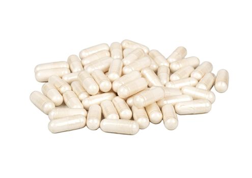 Scattered medical capsules on a white background