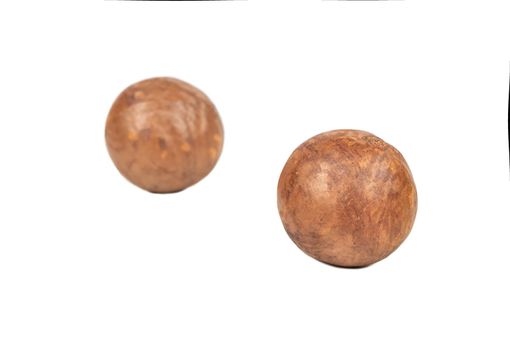 Two macadamia nuts in a shell isolated on a white background