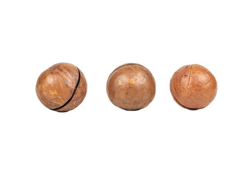 Three macadamia nuts in a shell isolated on a white background